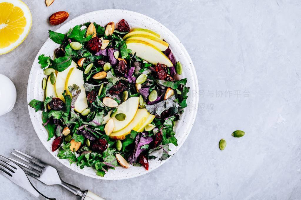 Apple Cranberry Kale Salad bowl with dry cranberries, almonds an