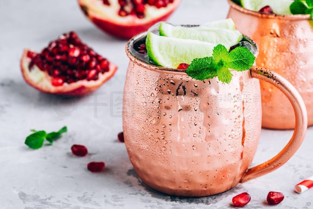 Iced Cold Moscow Mule cocktail with lime and pomegranate