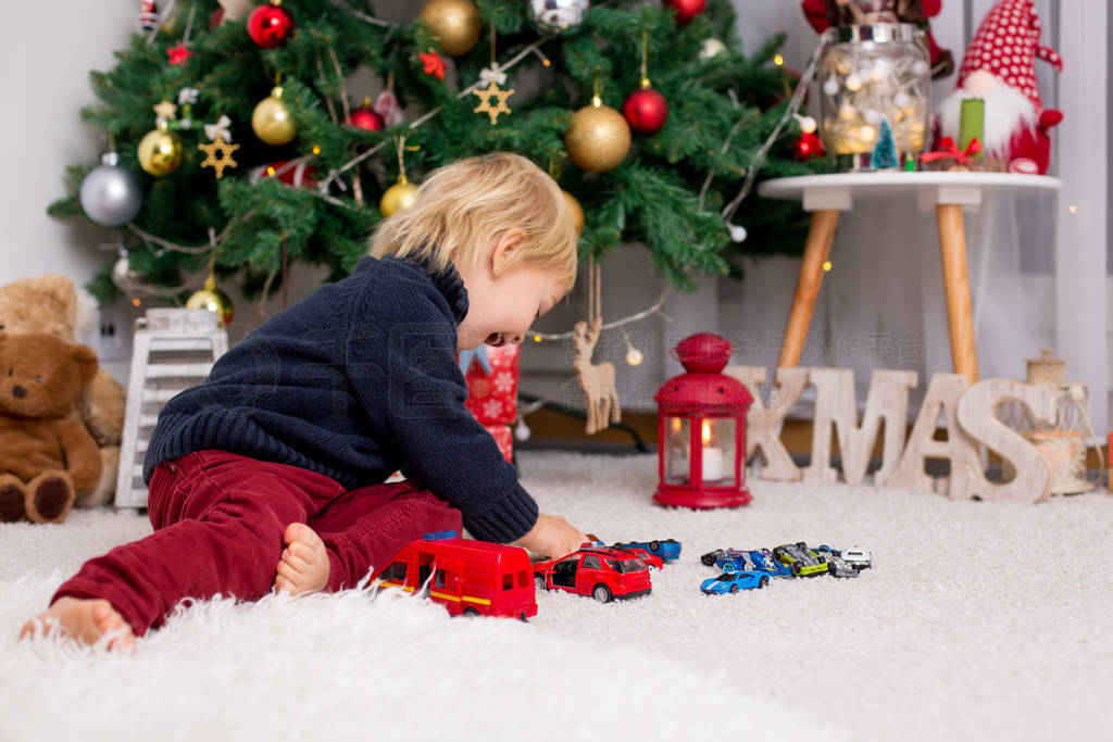 Blonde toddler boy, playing with car toys