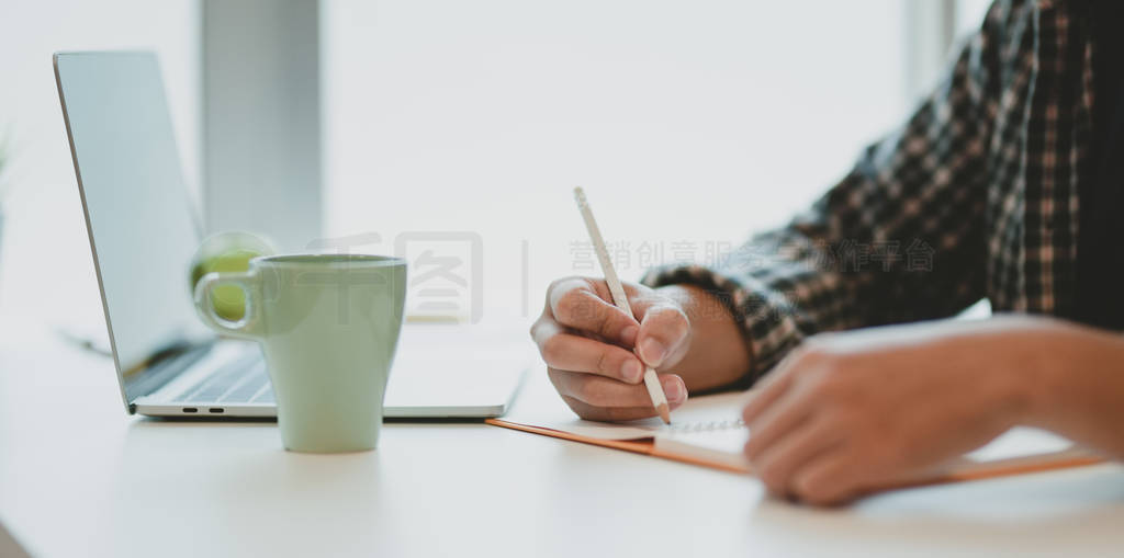 Close-up of male freelancer writing his ideas