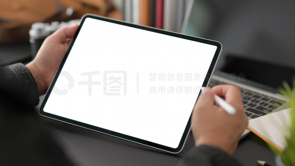 Cropped shot of young businessman using blank screen digital tab