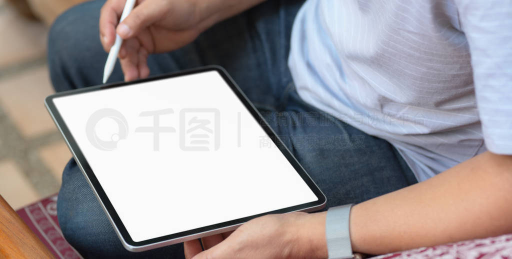 Cropped shot of businessman using blank screen tablet while work