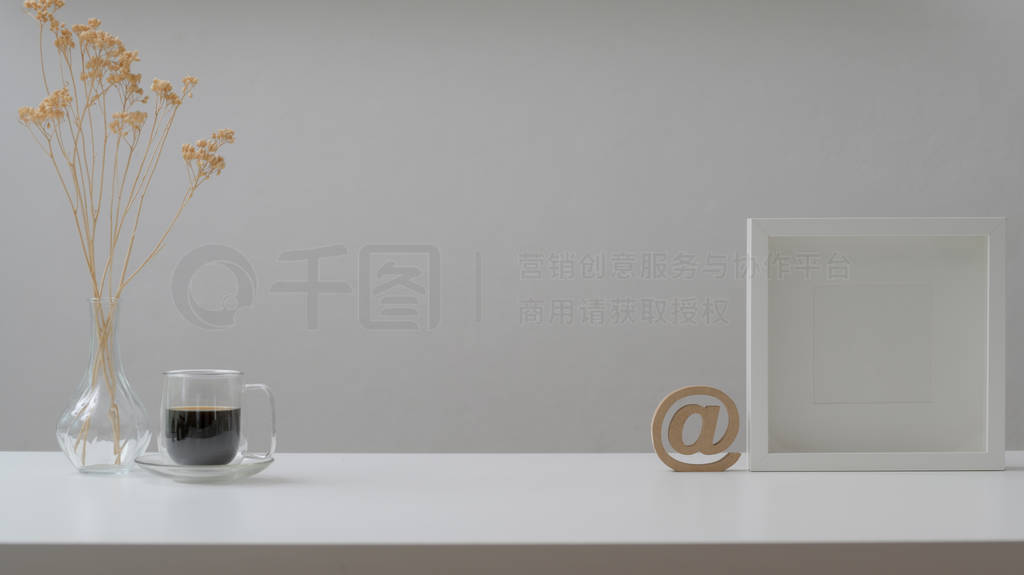 Cropped shot of workspace with mock up frames, coffee cup and de