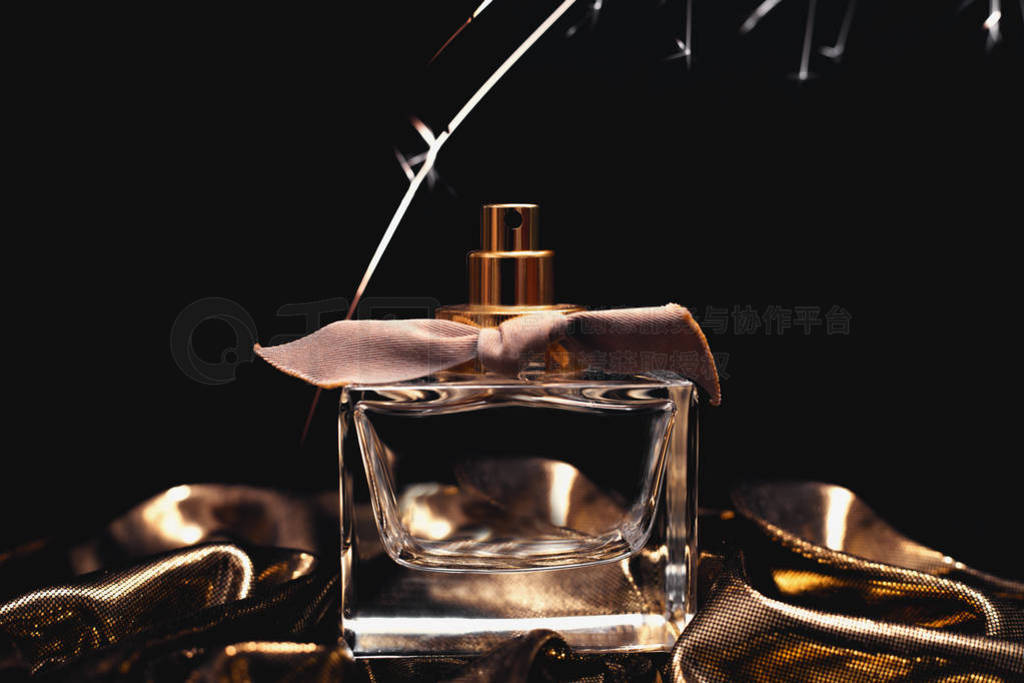 female perfume bottle on dark background