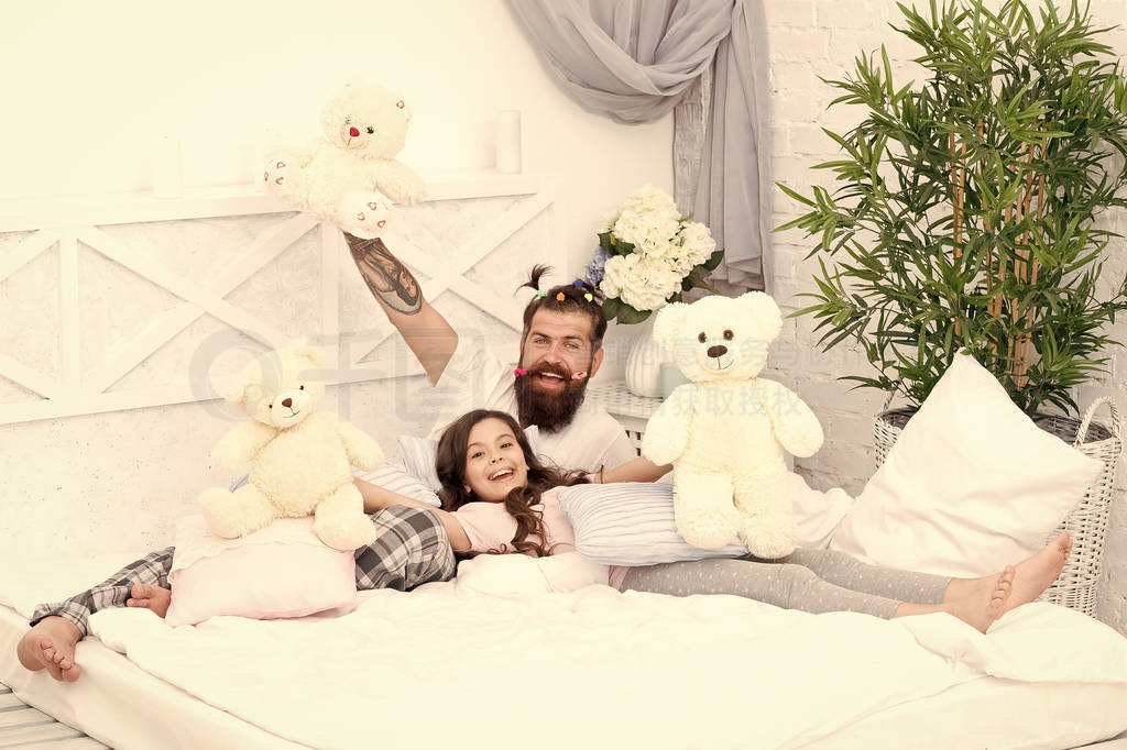 Ending of crazy evening. Dad and girl relaxing bedroom. Pajamas