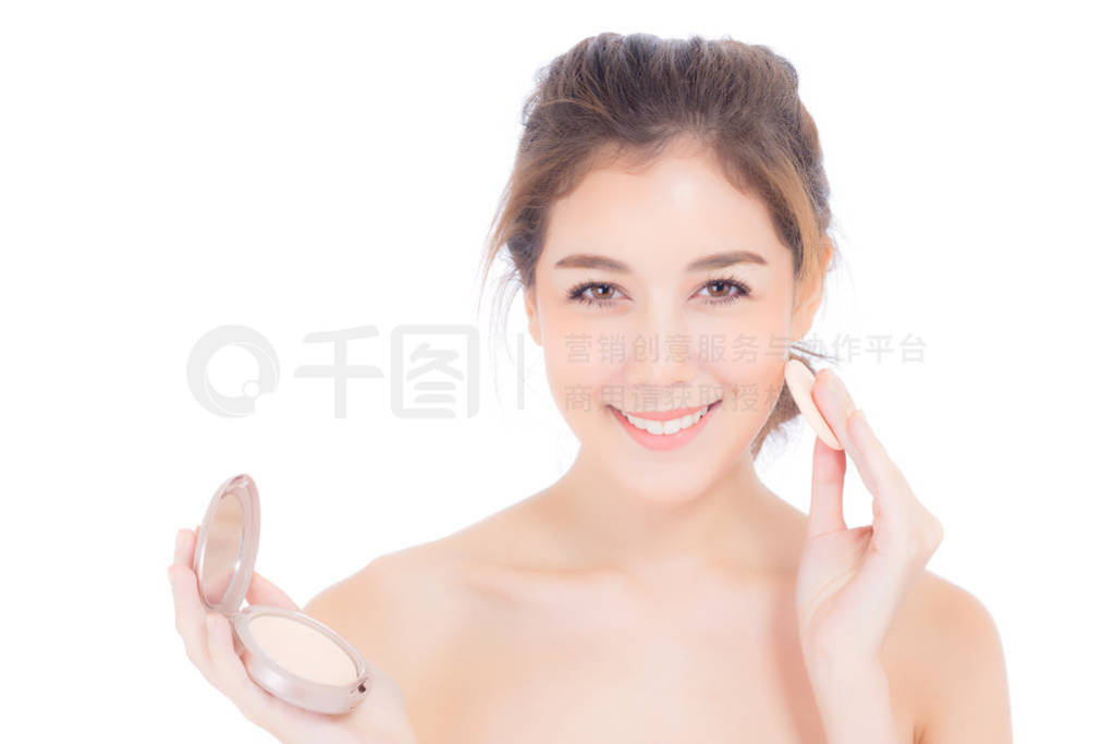 Portrait of beautiful asian woman applying powder puff at cheek