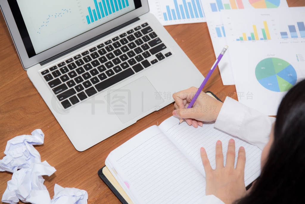 Businesswoman writing on notebook at desk, asian woman with not