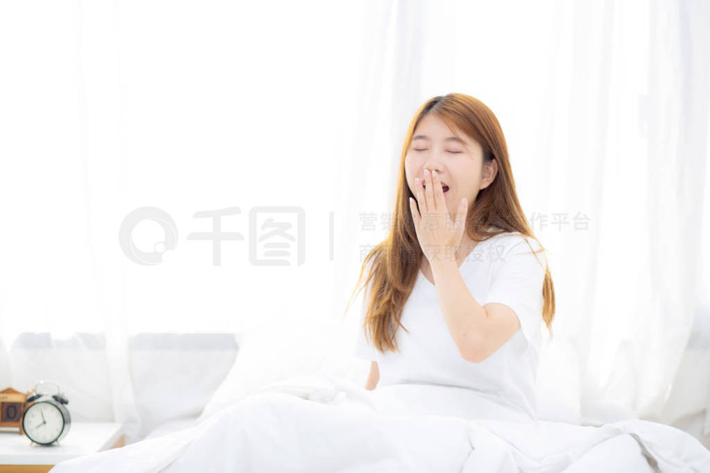 Beautiful of portrait young asian woman yawn sitting with sleep
