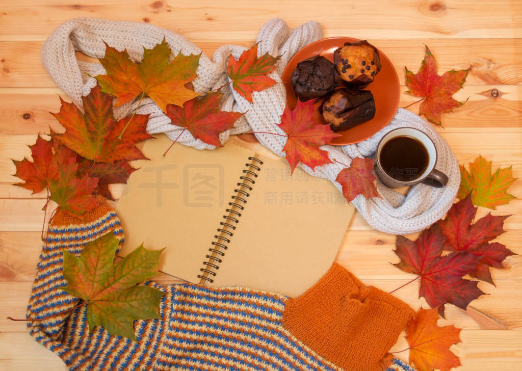 Empty notebook, mug of hot coffee, autumn maple leaves, muffins