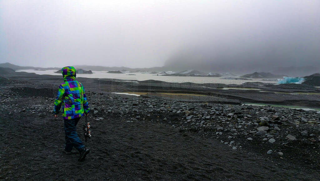 Overcast weather glacier hiking in Iceland volcanic black stone