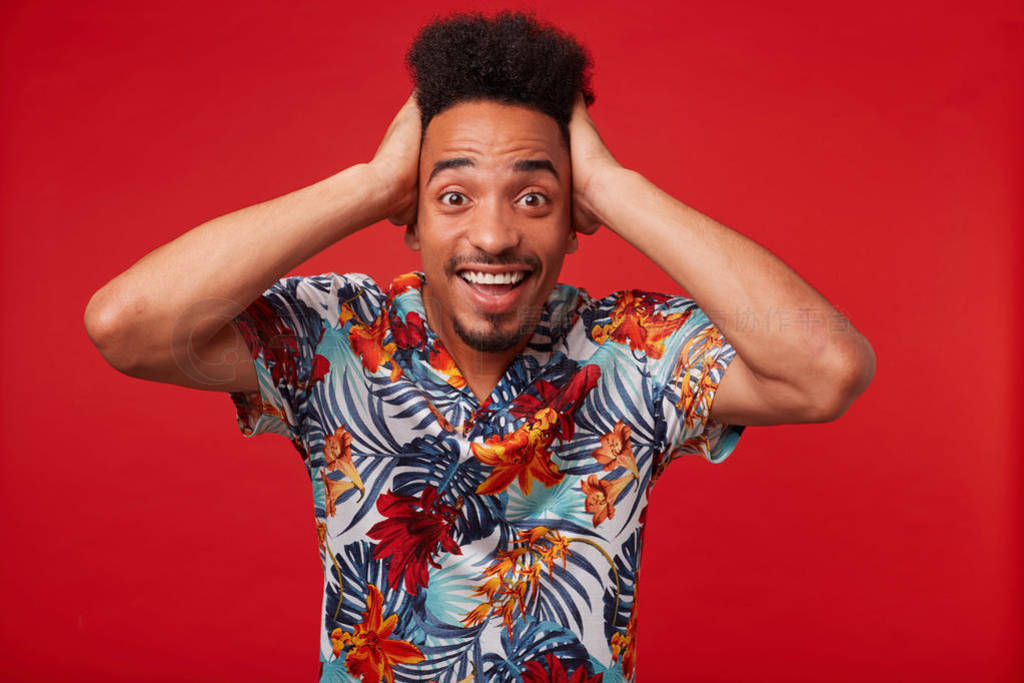 Portrait of young African American man in Hawaiian shirt, looks