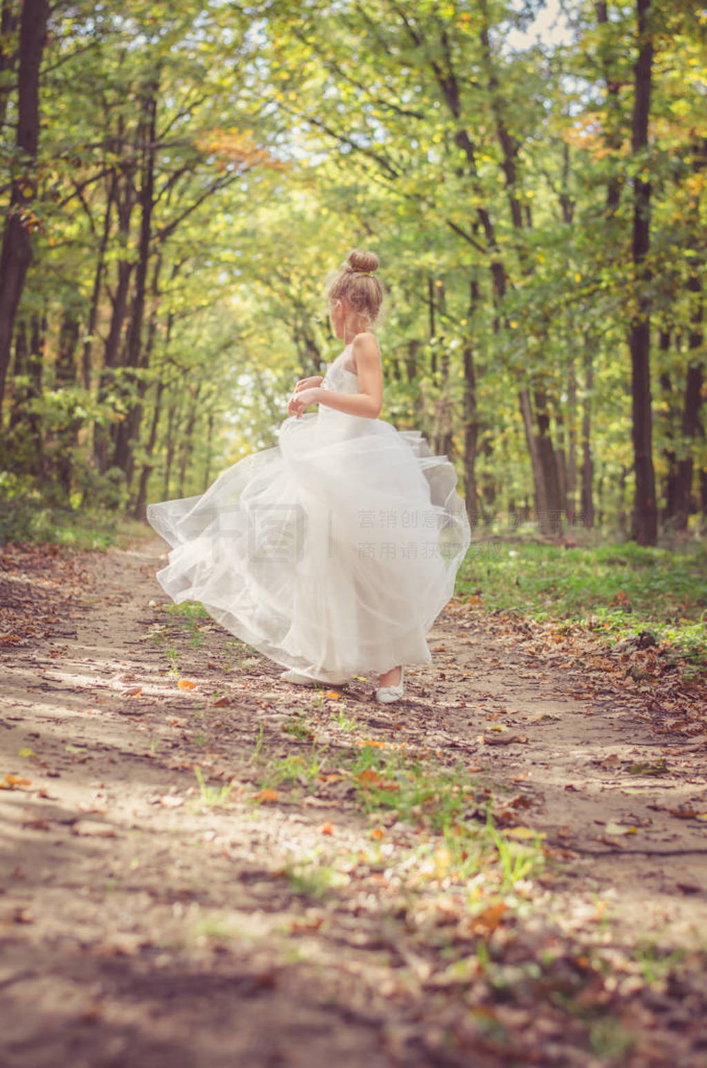 adorable child in long white wedding dress