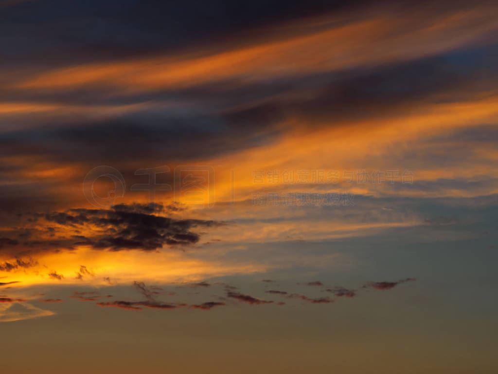 Clouds on a sky background illuminated by the sun's rays of the