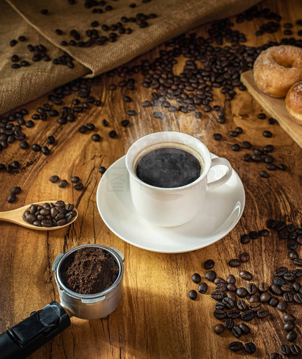 Coffee cup and roasted coffee beans. on wooden background with s