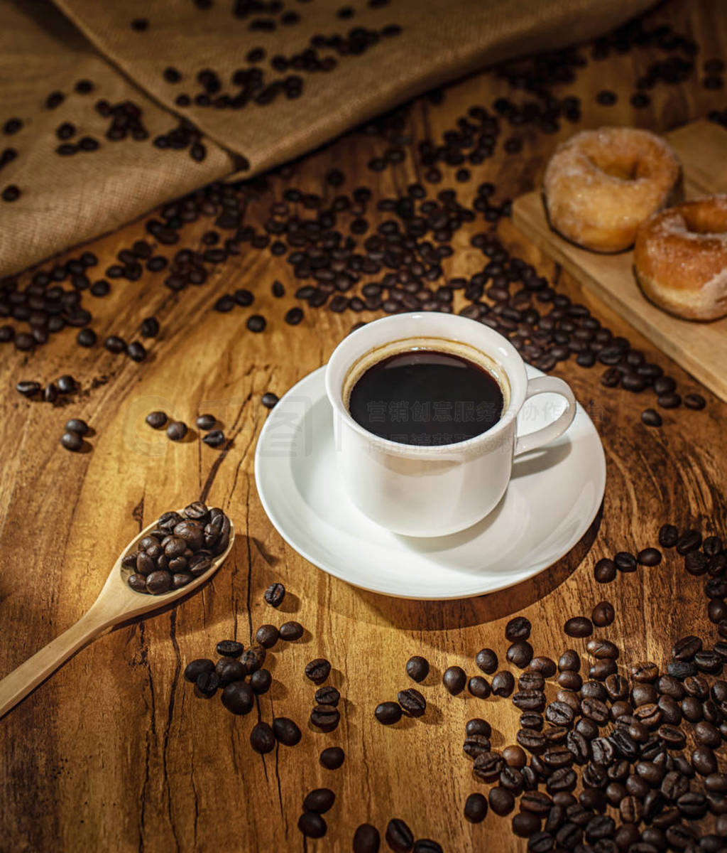 Coffee cup and roasted coffee beans. on wooden background with s