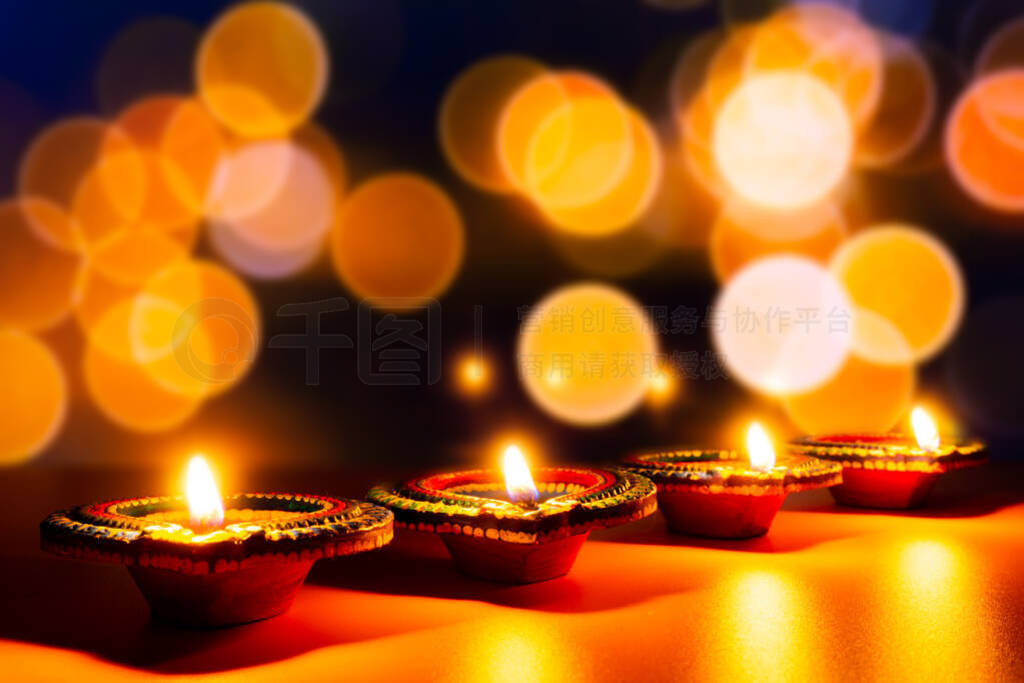 Indian festival Diwali, Diya oil lamps lit on colorful rangoli.