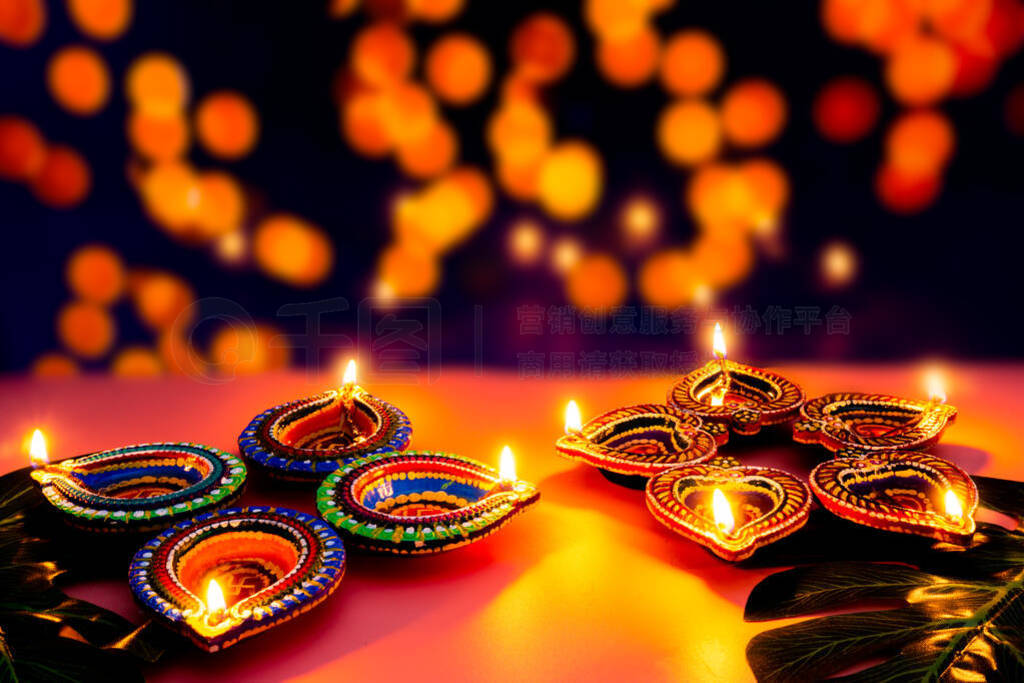 Indian festival Diwali, Diya oil lamps lit on colorful rangoli.