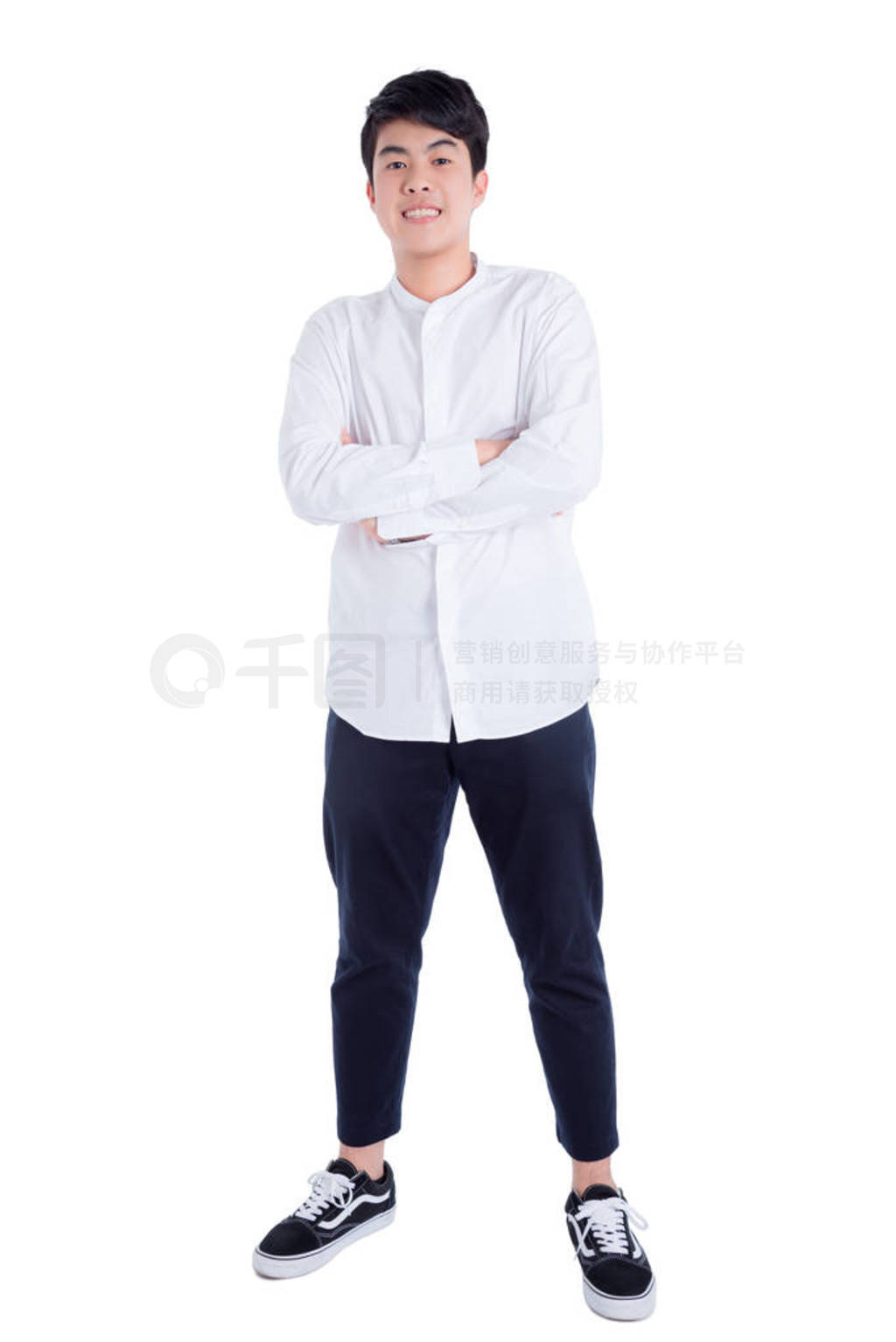 Young handsome man wearing white shirt standing and smiles