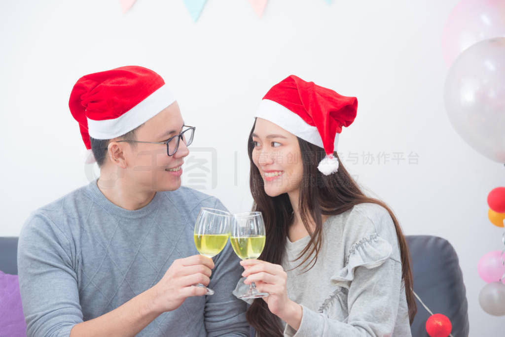 Young asian couple celebrating christmas holiday with champagne