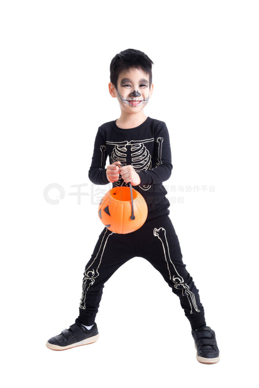 Little boy in skeleton costume for halloween celebration