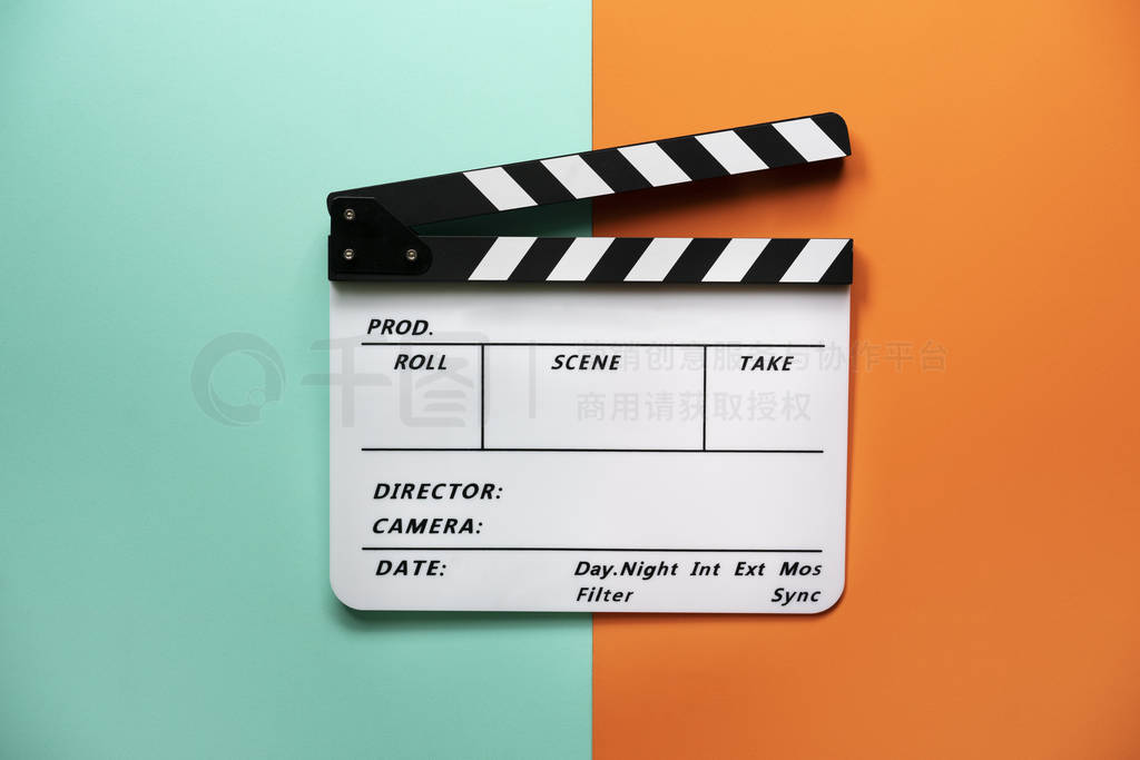 movie clapper on color table background; film, cinema and video