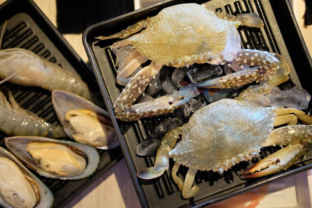 Fresh or many raw seafood on black tray