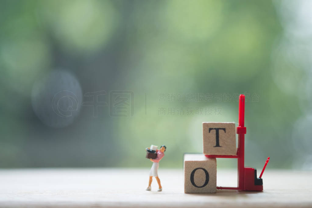 Miniature people: Woman working hard work and with text block