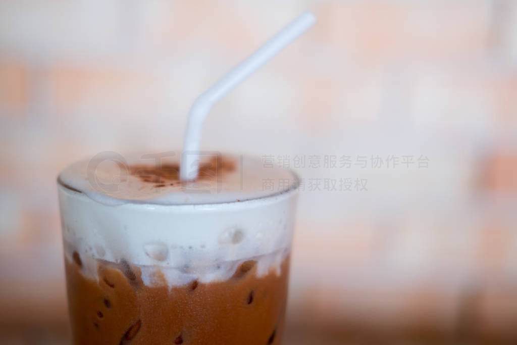 Glass of iced cocoa drink and milk foam