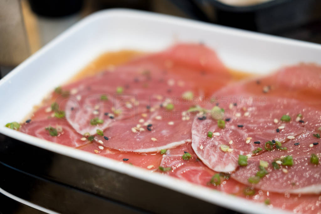 Raw pork with scallion sliced topped with teriyaki sauce