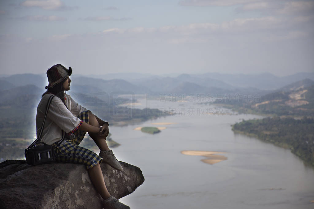 Asian thai woman travel visit and posing sitting on ridge stone