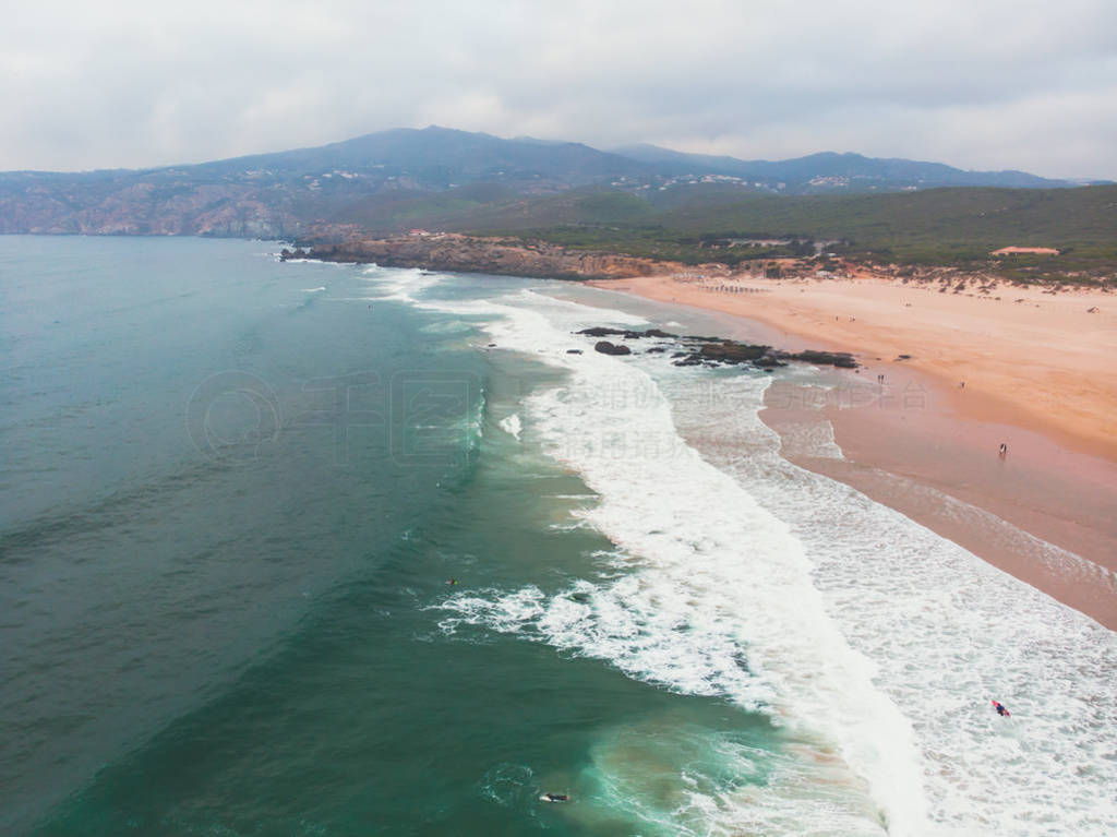 s Estoril coast, municipality of Cascais, with surfers surfing o