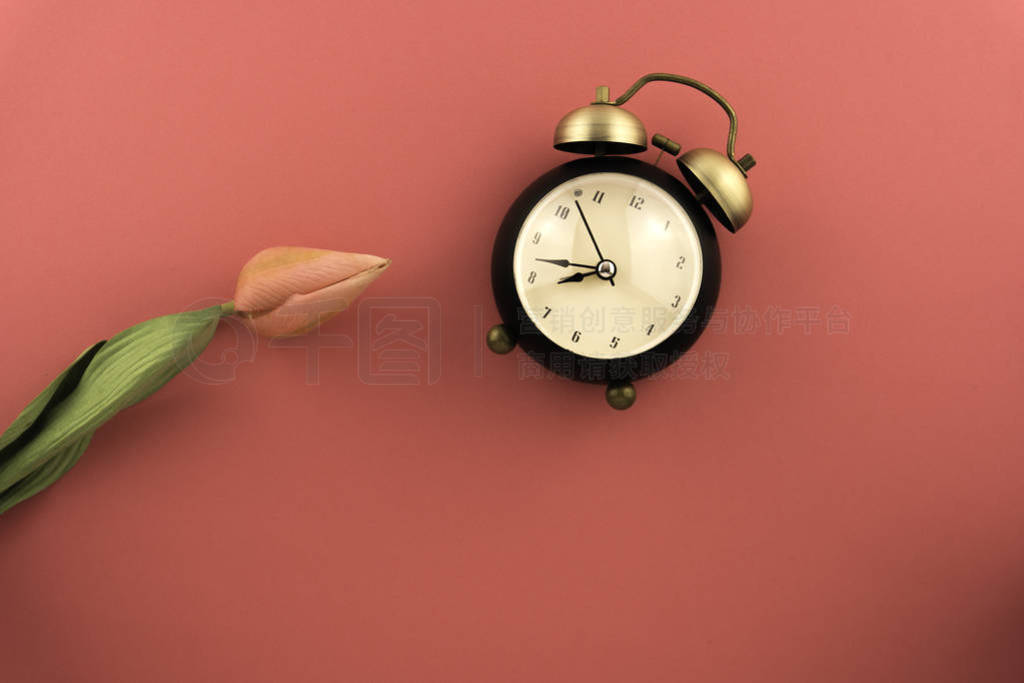 Clock on top view, pink background with soft focus. minimalist,