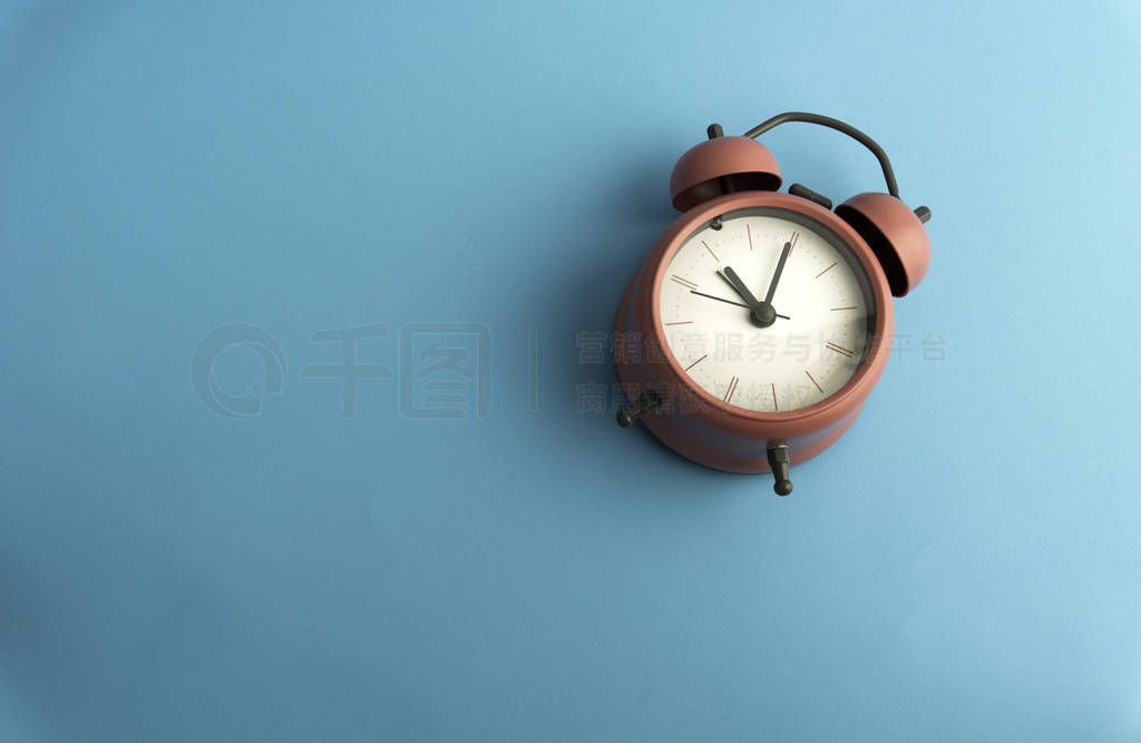 Creative flat lay concept top view of pink vintage alarm clock