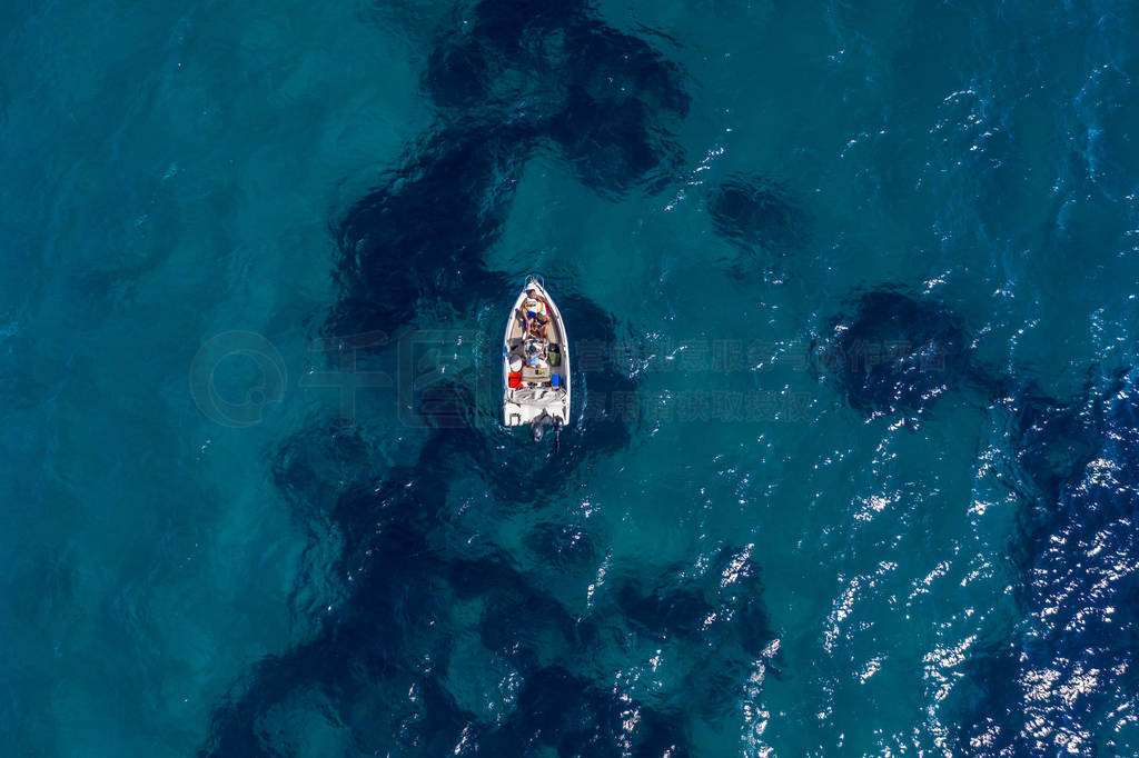 Aerial drone shot view of a boat in Ionian sea near Zakynthos Is