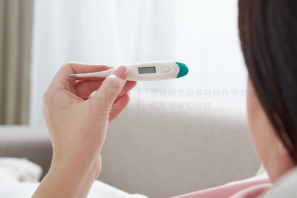 Woman holding a digital thermometer. Concept of fever, flue, vir