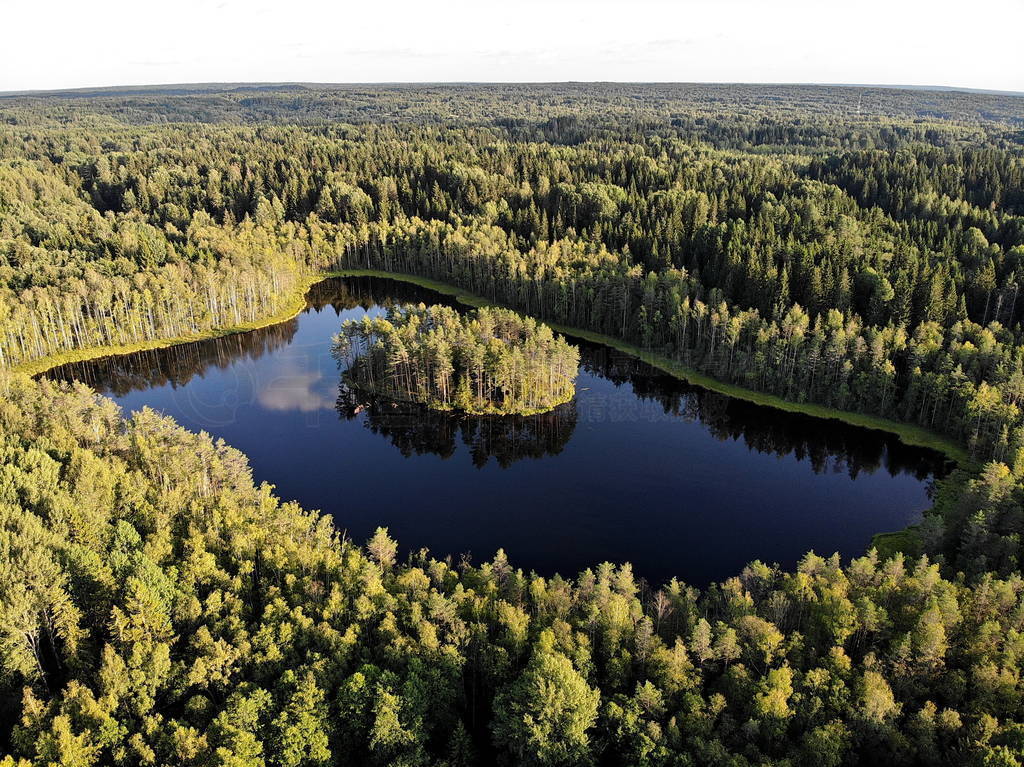 Aerial view of a lake with round island in the middle of the fo