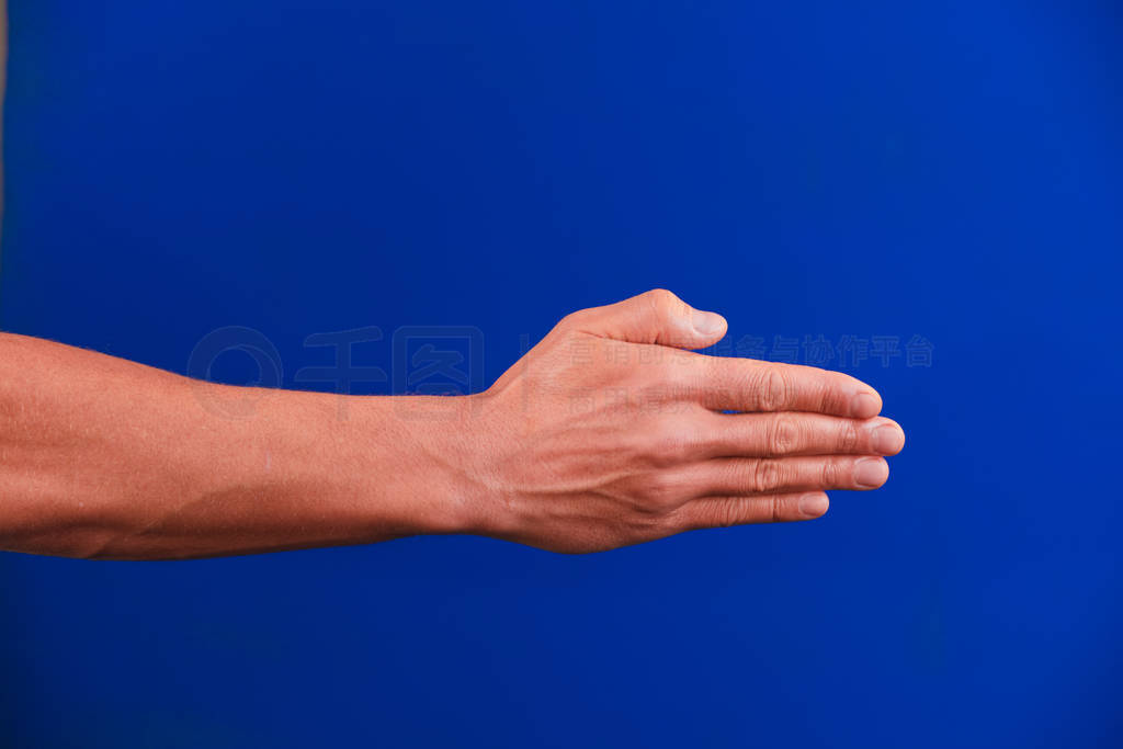 Human hand on blue background chroma-key.