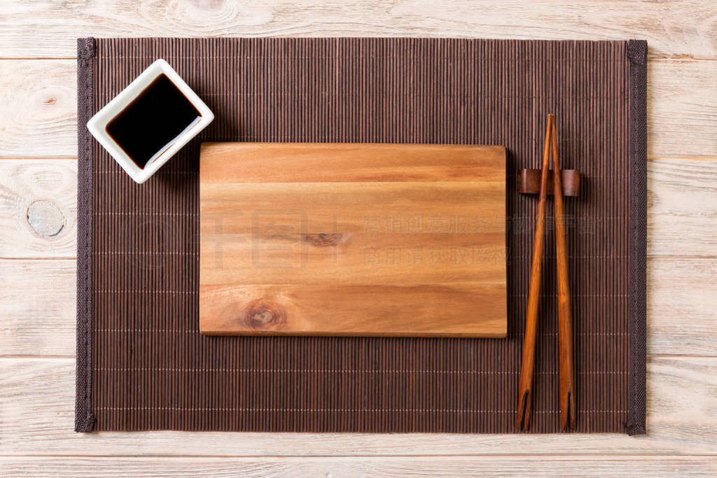 Empty rectangular wooden plate for sushi with sauce and chopstic