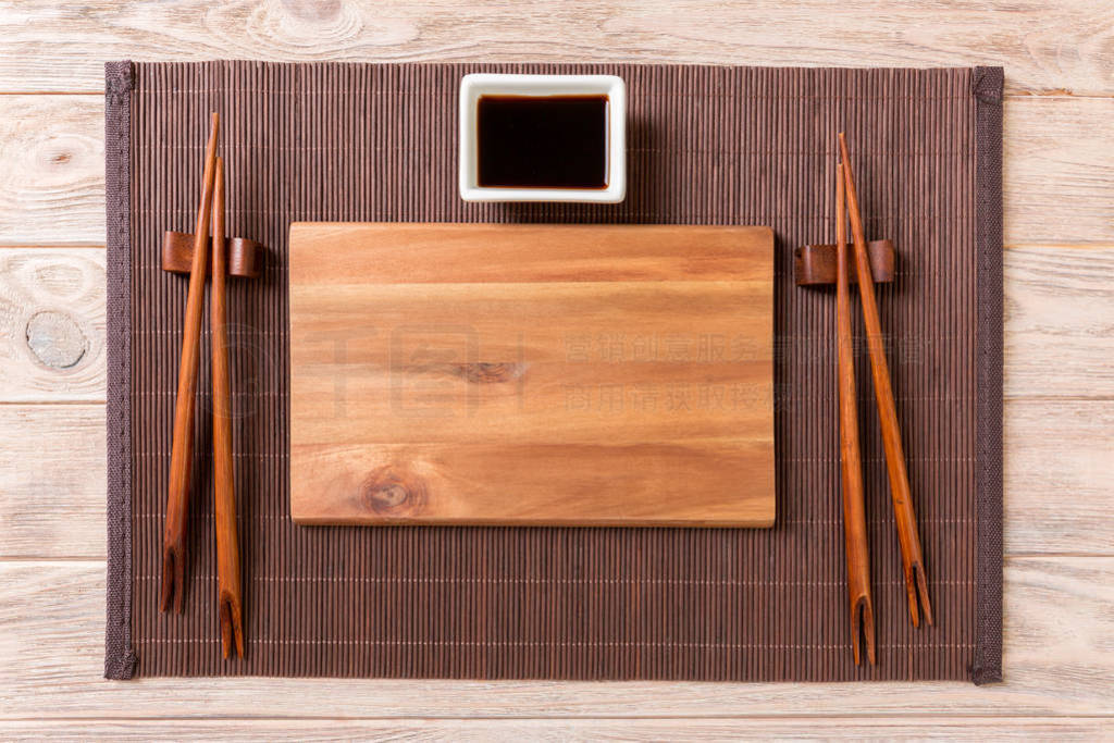 Empty rectangular wooden plate for sushi with sauce and chopstic