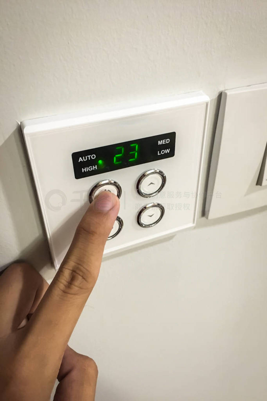A right hand switches on the air conditioning system