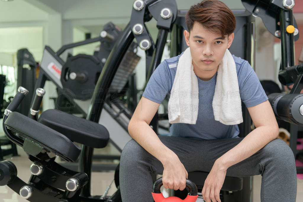 Asian man lifting dumbbells in weight training