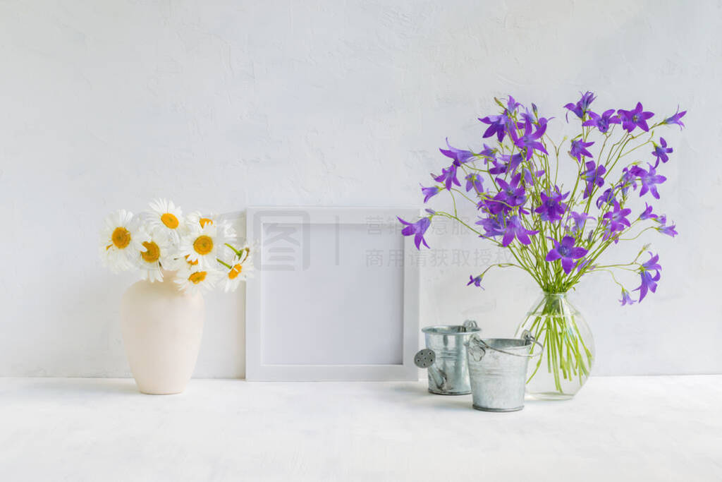 Mockup with a white frame and summer flowers in a vase