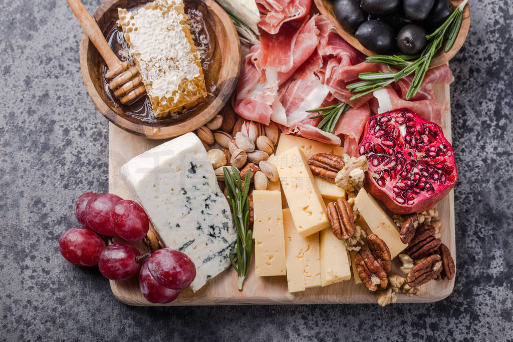 Traditional italian antipasto plate. Assorted cheeses on wooden