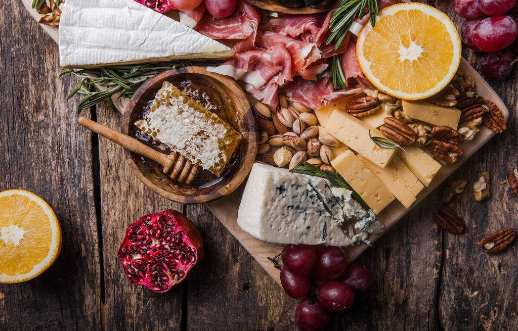 Traditional italian antipasto plate. Assorted cheeses on wooden