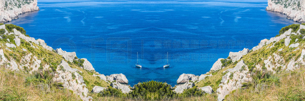 Lonely bay in picturesque seascape with 2 sailboats