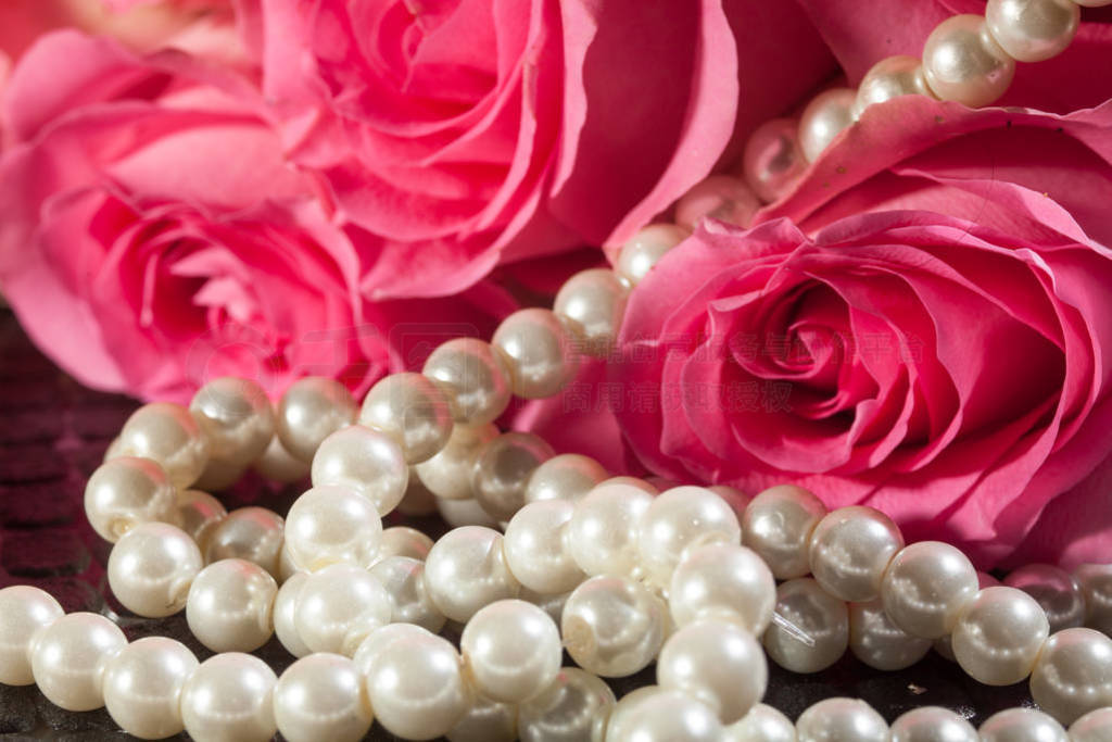 Beautiful pink roses and white pearls. Concept of beauty for wom