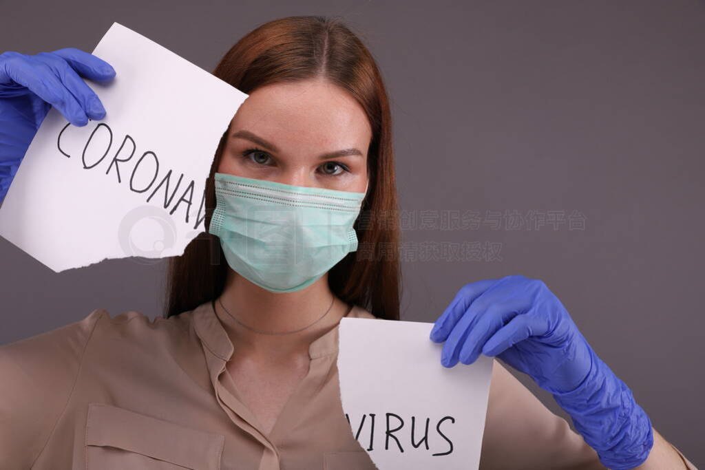 Woman tears sheet of paper with sign