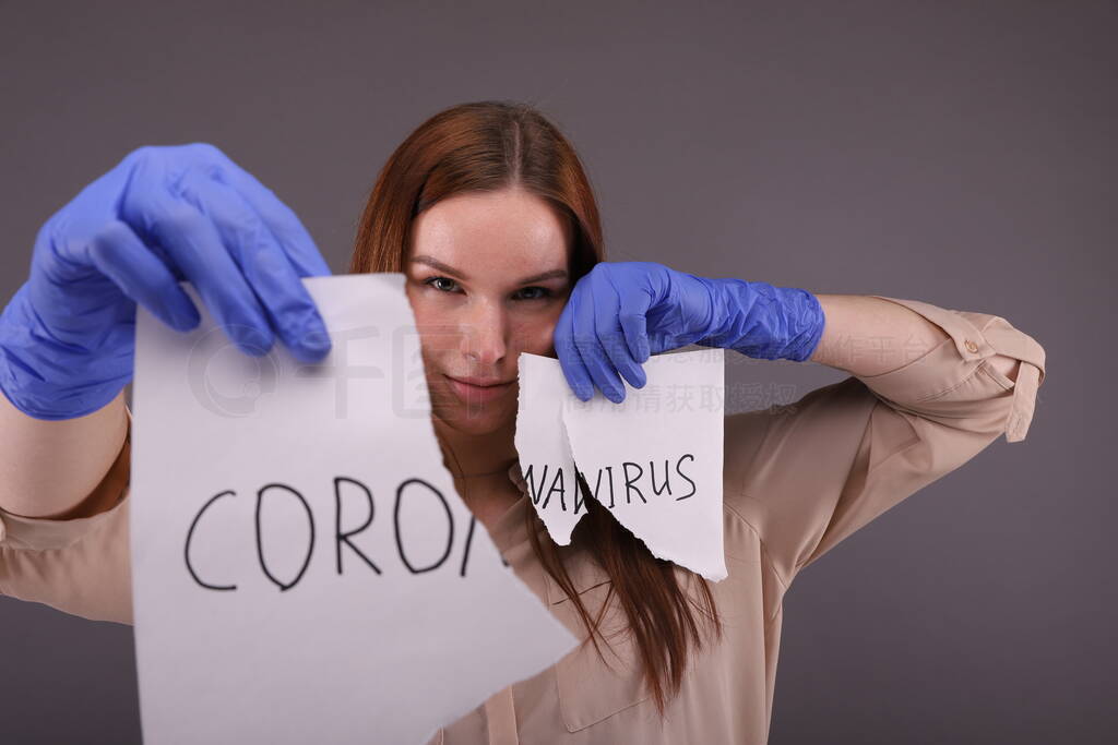 Woman holding pieces of paper with sign