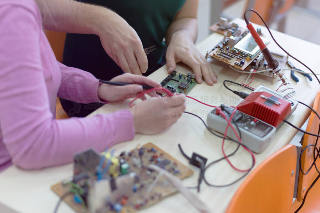 Group of young engineers working on robotics project. Scientist