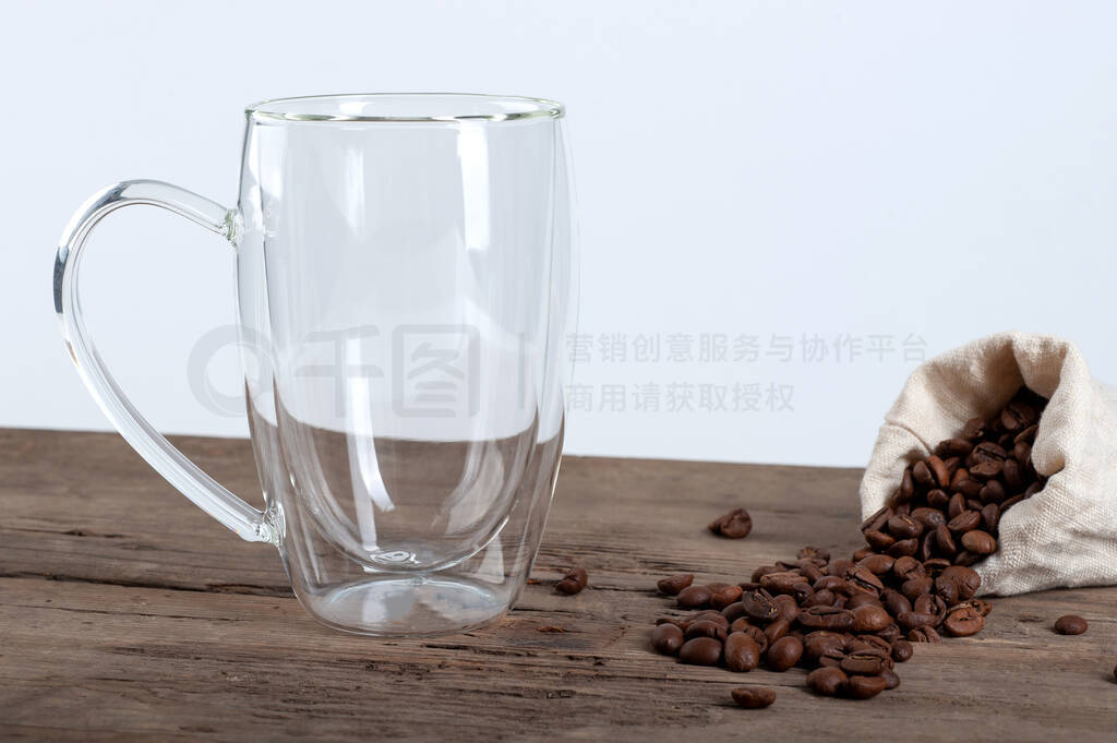 an empty transparent mug with a double bottom stands on an old